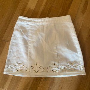 White mini skirt with cutout embroidered detailing